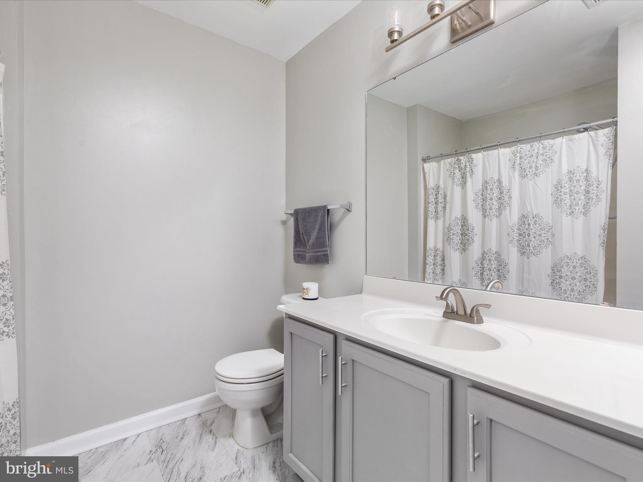 7100 Wheeling Way Gainesville, VA 20155 - Photo 29 of 39 a bathroom with a sink toilet and a mirror