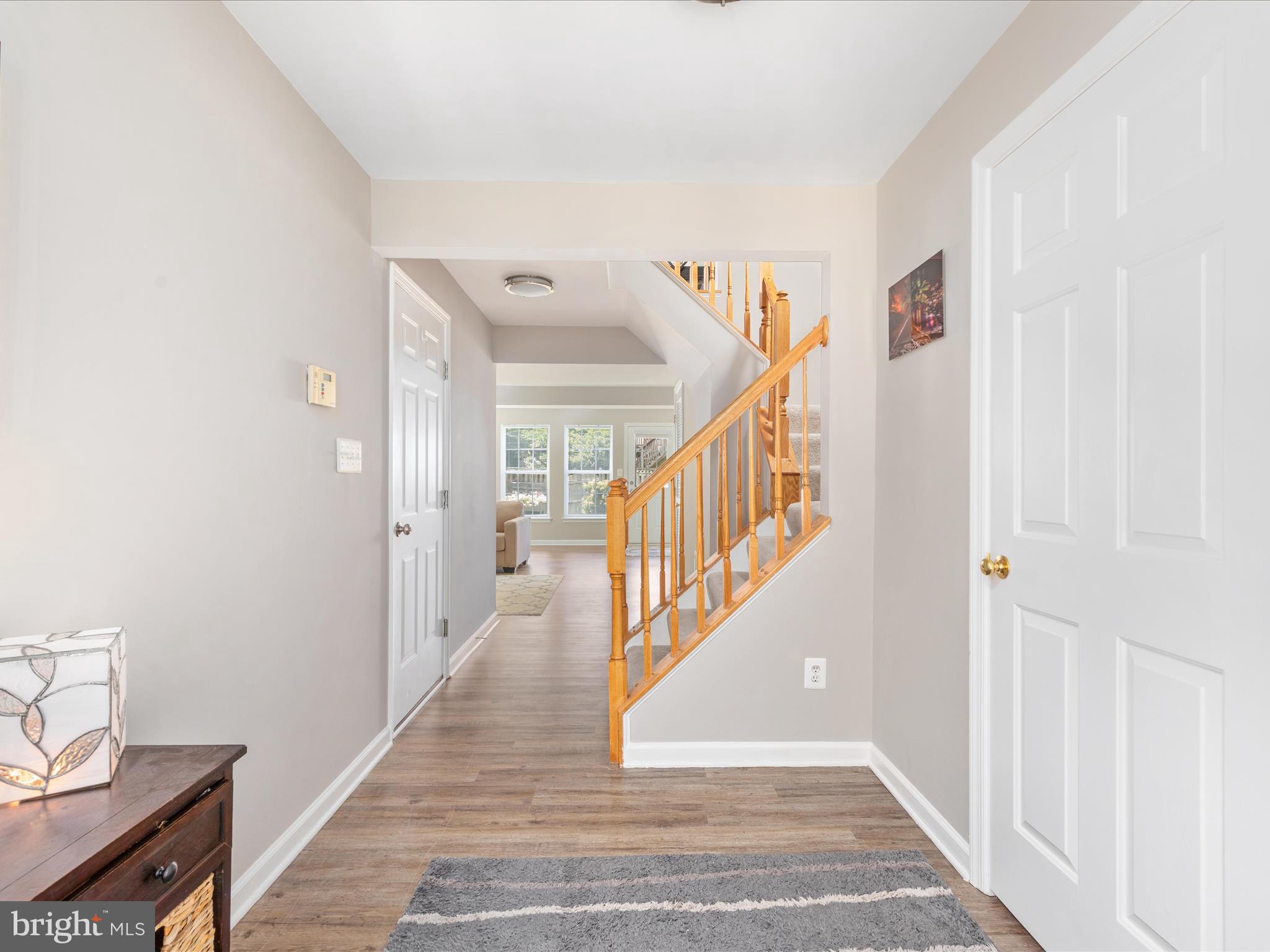 7100 Wheeling Way Gainesville, VA 20155 - Photo 5 of 39 a view of a hallway with wooden floor and staircase