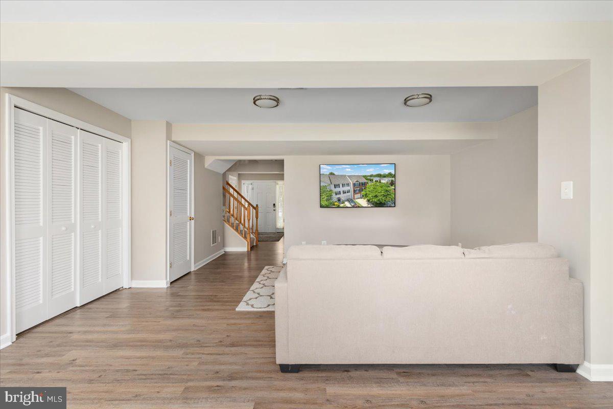 7100 Wheeling Way Gainesville, VA 20155 - Photo 9 of 39 a view of an empty room with wooden floor and a window