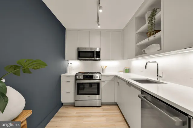 a kitchen with a sink stove and microwave