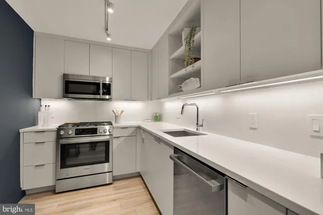 a kitchen with a sink stove and microwave