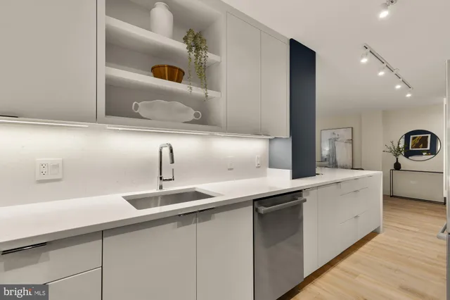 a kitchen with cabinets a sink and appliances