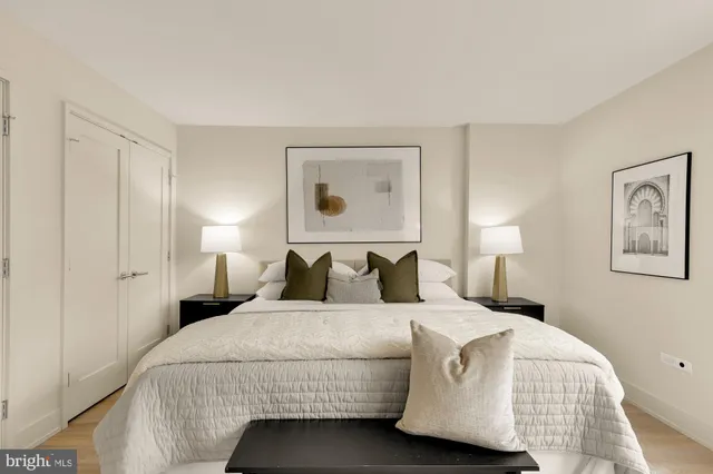 a bedroom with a bed and lamp