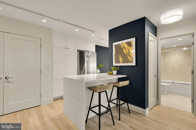 a view of a workspace with furniture and wooden floor