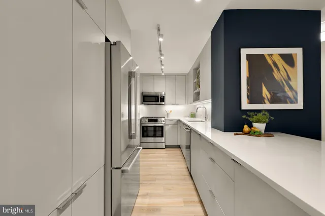 a kitchen with stainless steel appliances a refrigerator and a stove