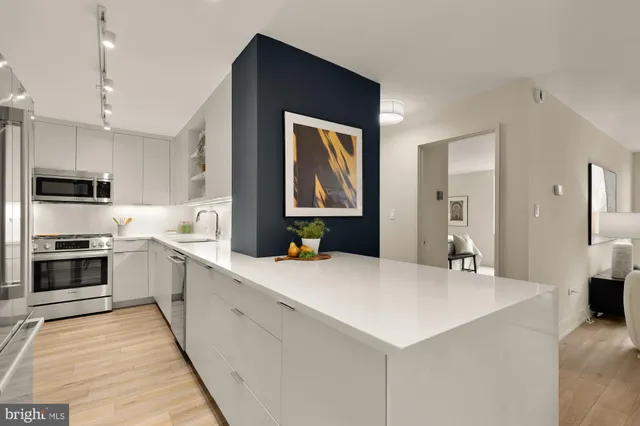 a large kitchen with a stove a sink and a refrigerator