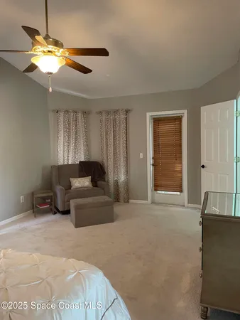 a living room with furniture a chandelier and a window