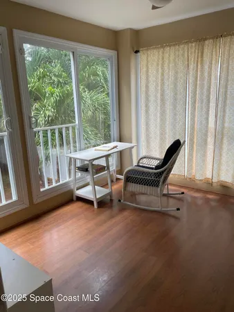 a living room with a chair and a large window