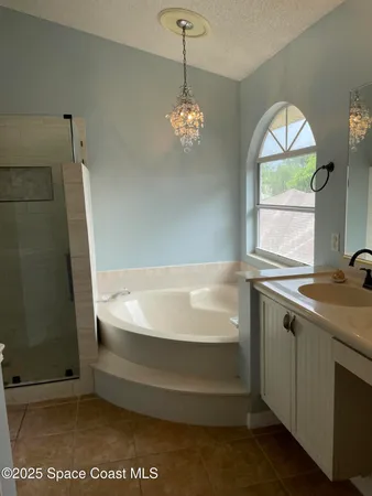 a spacious bathroom with a bathtub and a shower