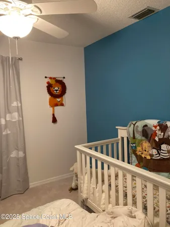 a bedroom that has a bed and a chair in it