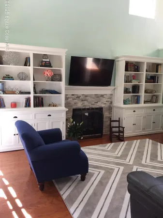 a living room with furniture fireplace and flat screen tv