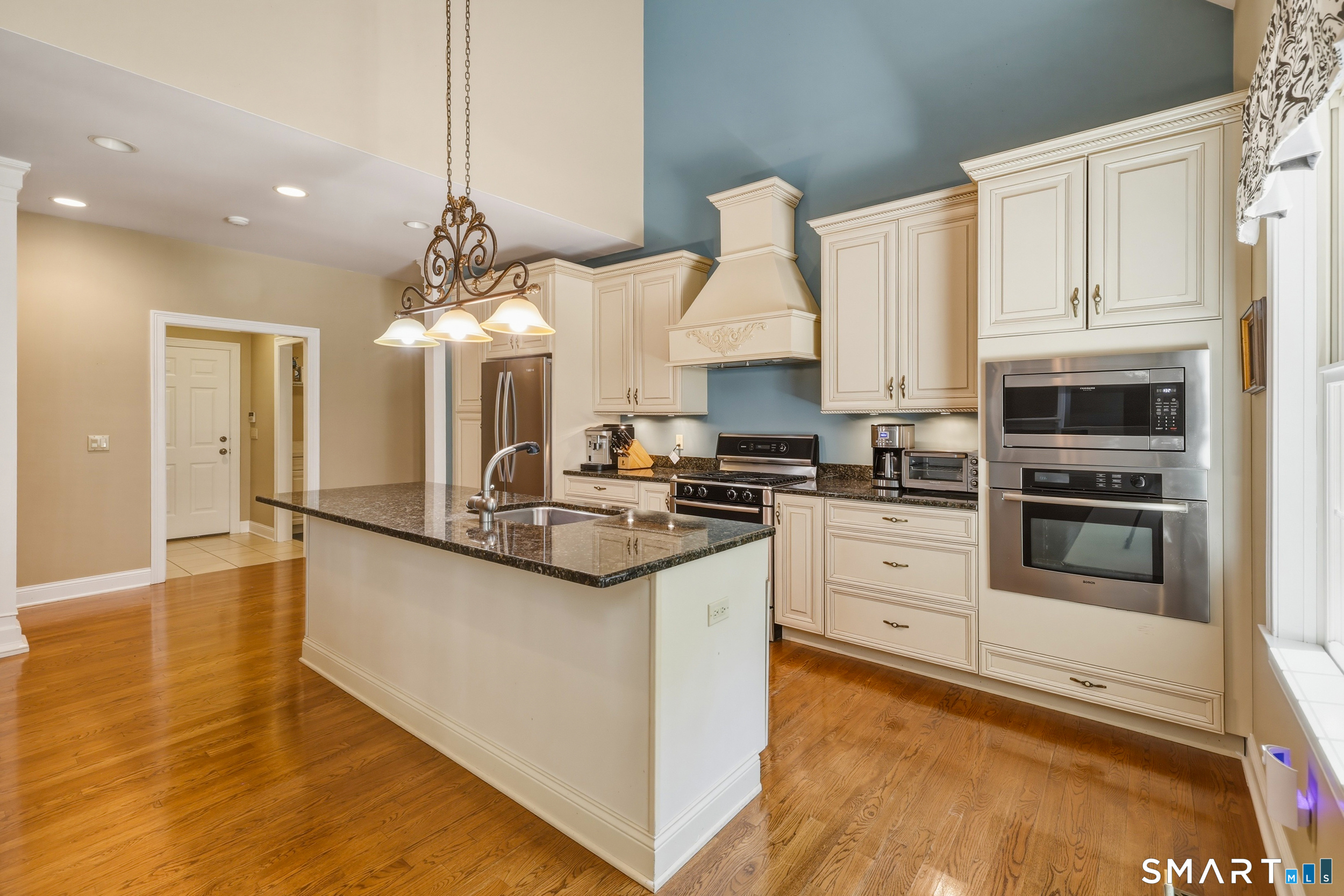 122 Lower Road Guilford, CT 06437 - Photo 12 of 40 The kitchen features a cathedral ceiling with recessed lighting, granite countertops, and a central island with sink. Cabinetry includes dovetail construction with soft-close, and built-in pantry for added storage space.