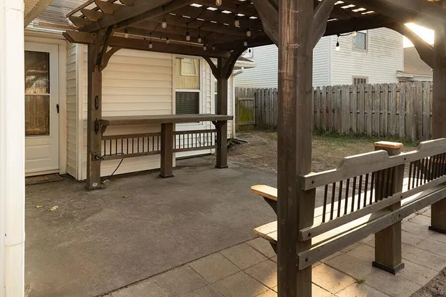 a view of house with backyard and tub