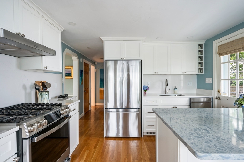 22 E Street Hull, MA 02045 - Photo 4 of 20 a kitchen with granite countertop a sink stove and refrigerator