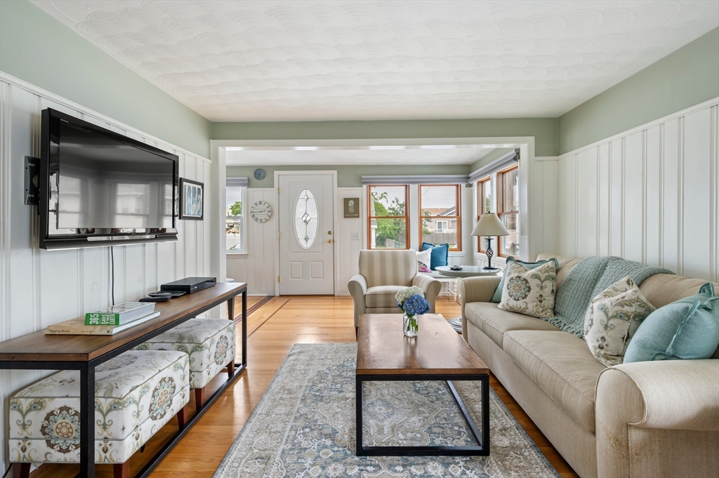 22 E Street Hull, MA 02045 - Photo 9 of 20 a living room with furniture and a flat screen tv
