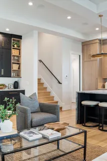 a kitchen with stainless steel appliances granite countertop a sink a stove and a wooden floors