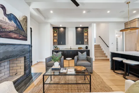 a living room with furniture and a kitchen view