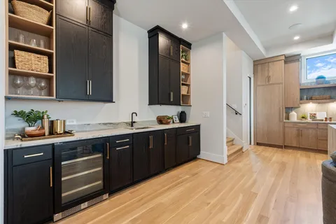 a kitchen with a table chairs stove and refrigerator