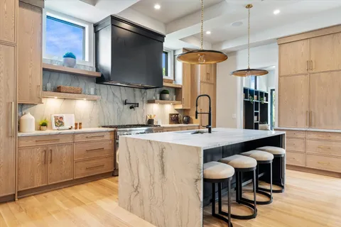 a kitchen with stainless steel appliances granite countertop a stove and a sink