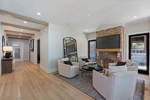 a living room with fireplace furniture and a flat screen tv