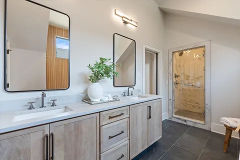 a bathroom with a granite countertop toilet sink and mirror