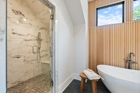 a hallway with white cabinets and a refrigerator
