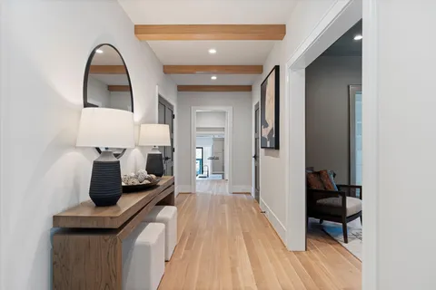 a room with furniture a rug and a potted plant