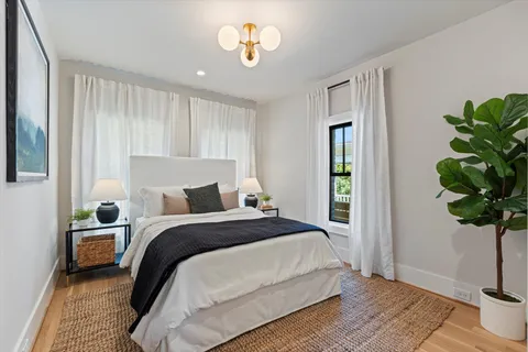 a bathroom with double vanity and a mirror