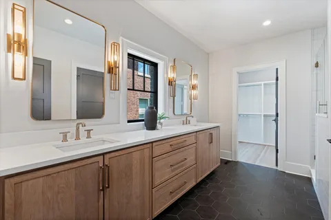 a bathroom with a double vanity sink and mirror