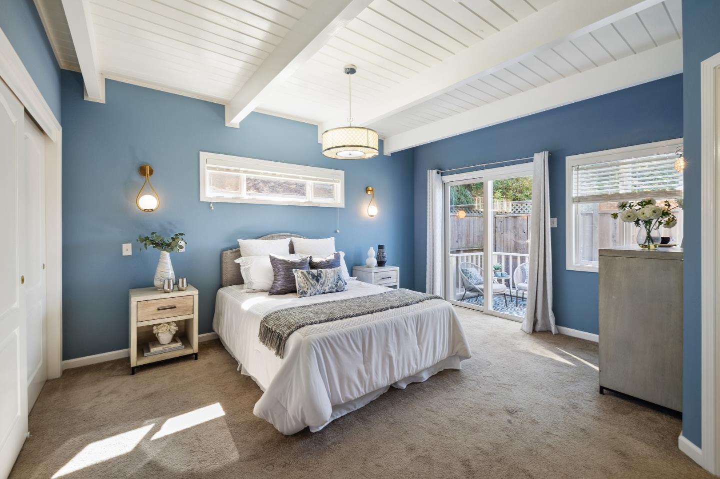 1156 Palou Drive Pacifica, CA 94044 - Photo 15 of 33 a bedroom with a bed and a chandelier