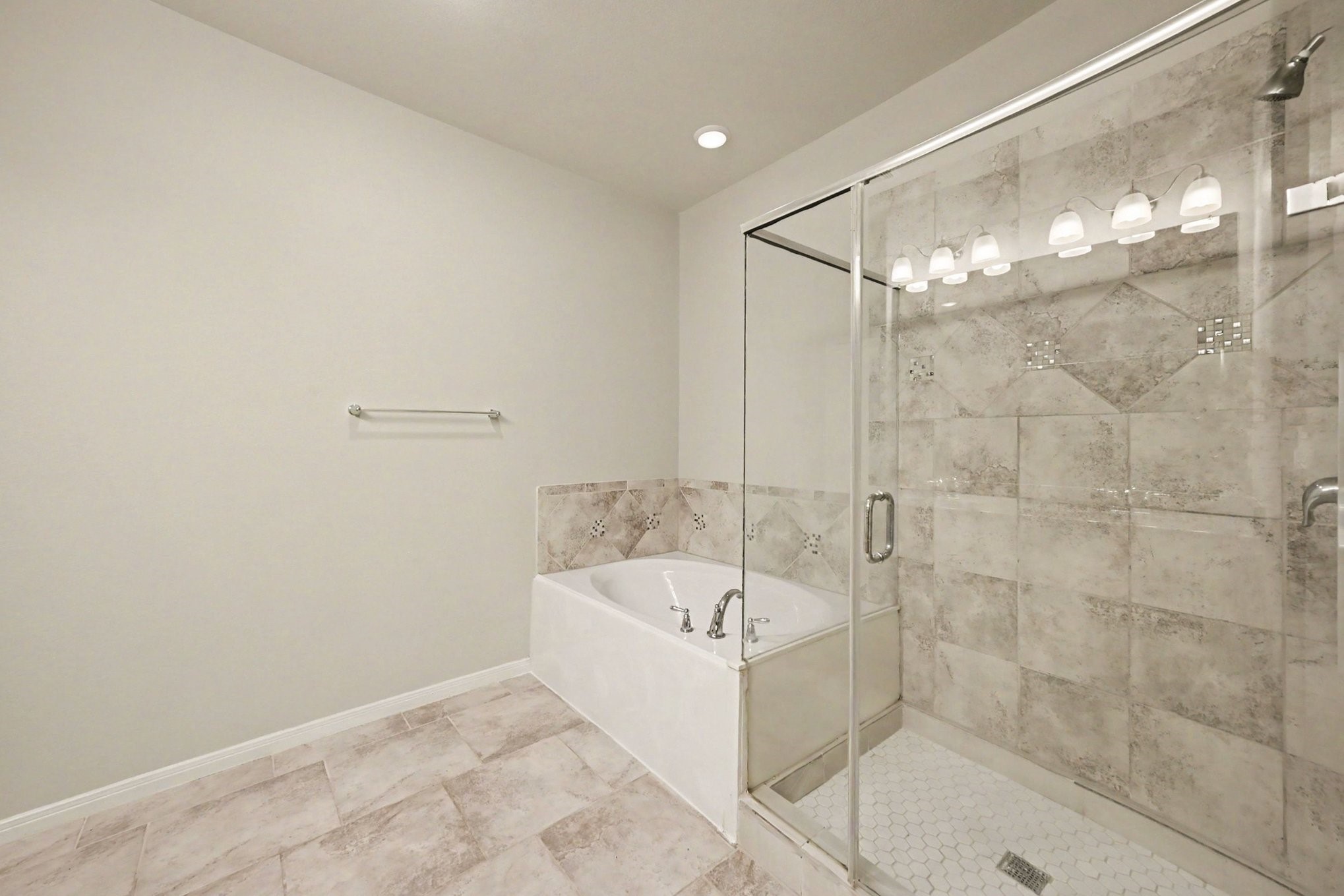 24554 Grayson Falls Lane Spring, TX 77389 - Photo 18 of 27 a bathroom with a bathtub and shower