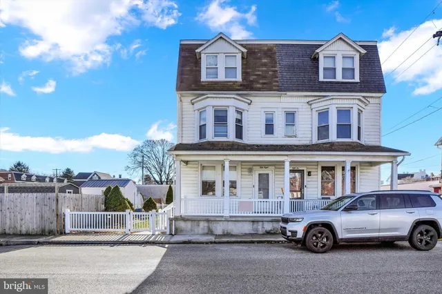 front a house with a car parked in front of it