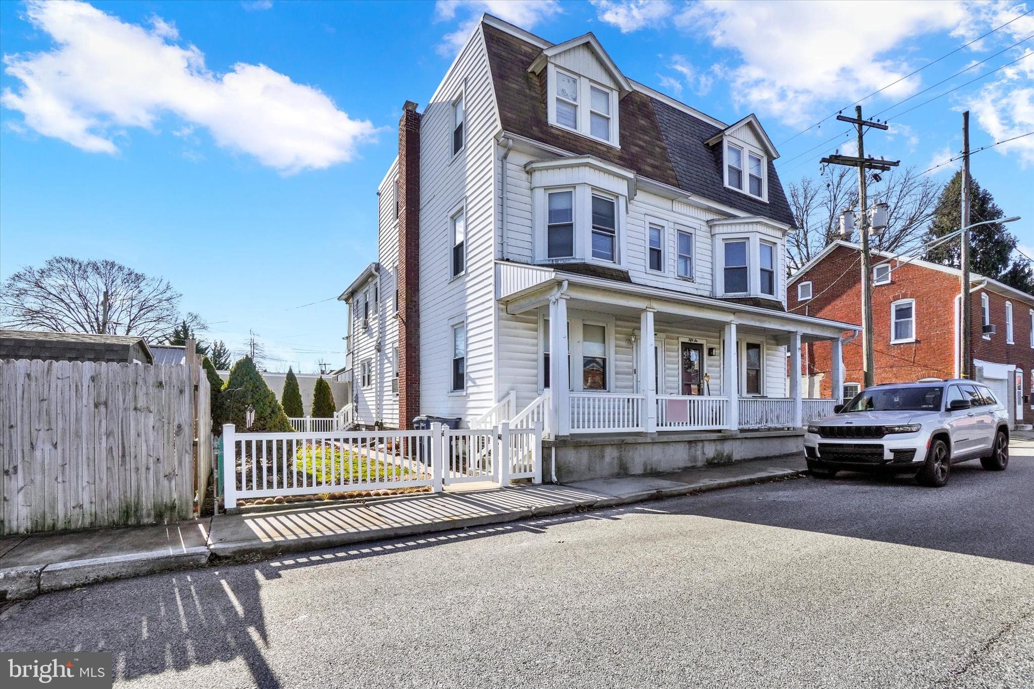 58 East Railroad Street Spring Grove, PA 17362 - Photo 2 of 24 a front view of a residential apartment building with a yard