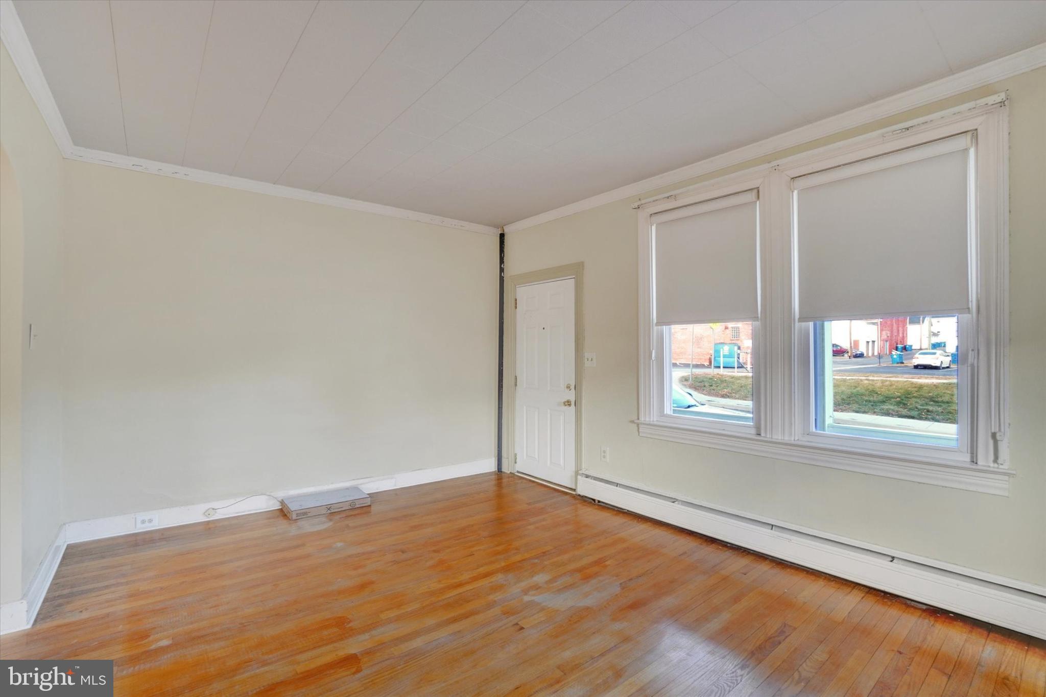 58 East Railroad Street Spring Grove, PA 17362 - Photo 3 of 24 an empty room with wooden floor and windows