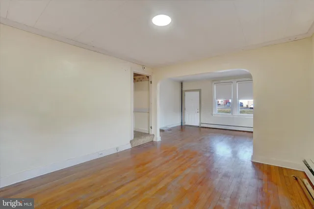 a view of an empty room and wooden floor