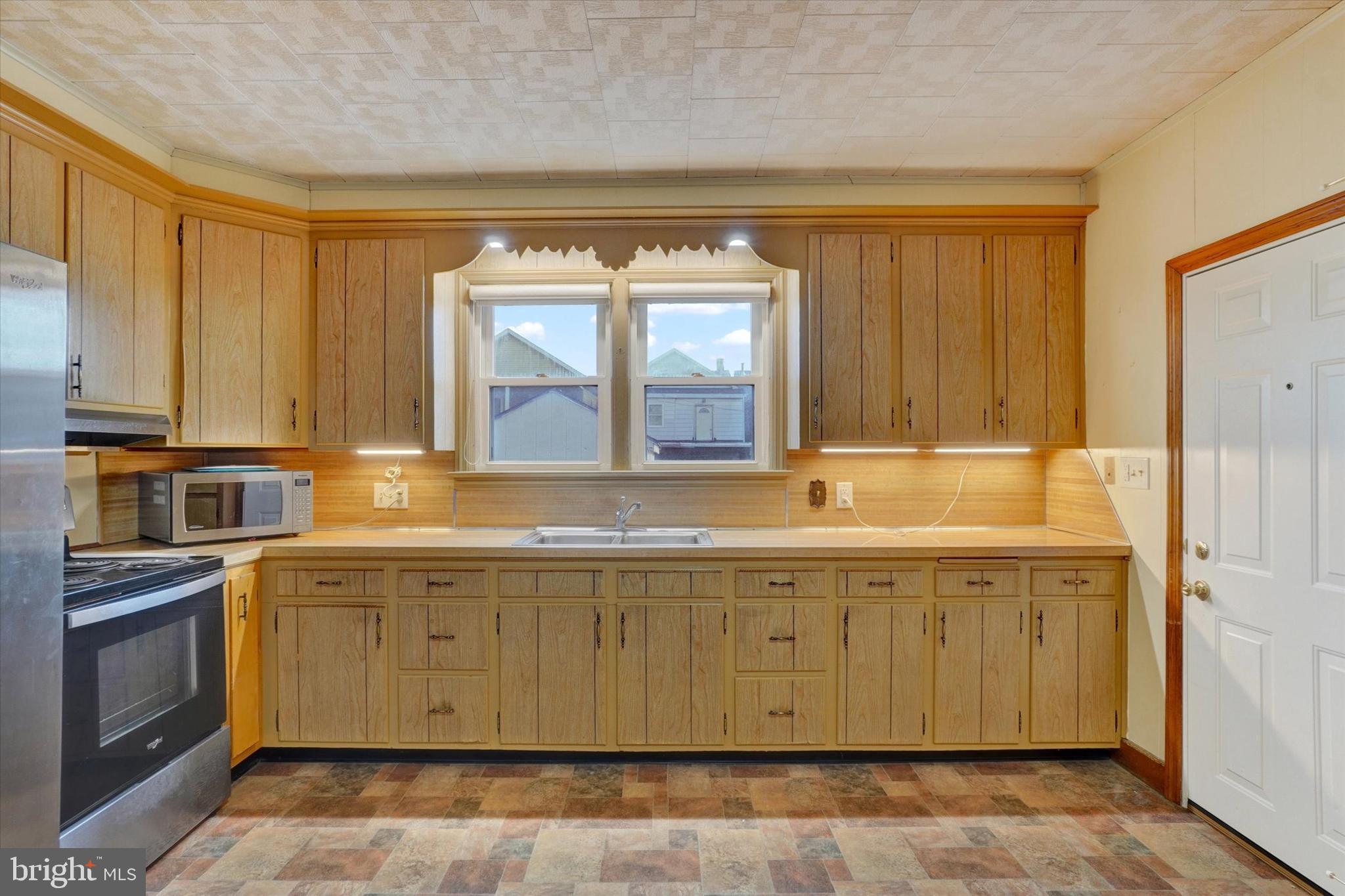 58 East Railroad Street Spring Grove, PA 17362 - Photo 8 of 24 a view of a kitchen with a sink a microwave and cabinets