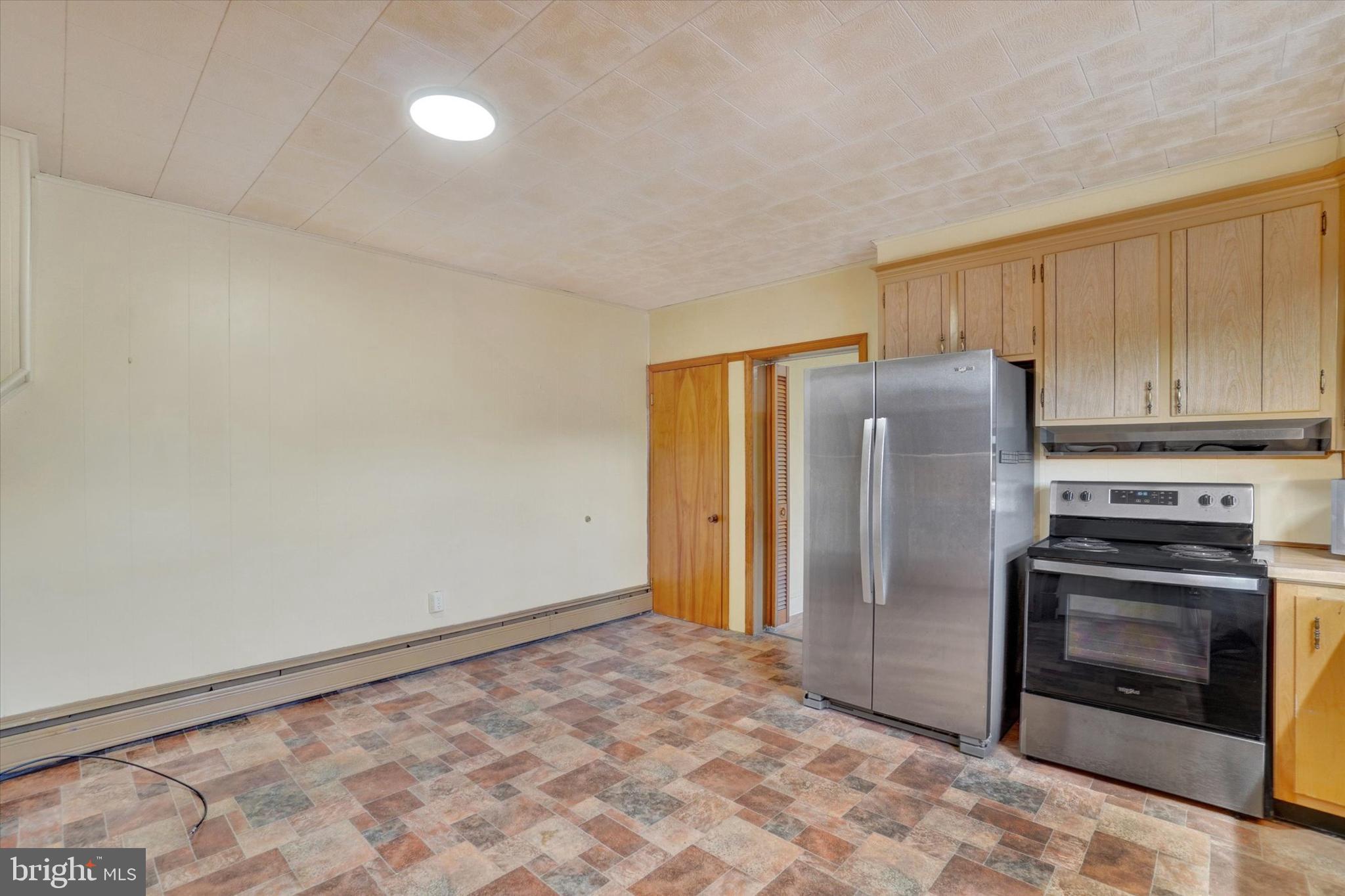58 East Railroad Street Spring Grove, PA 17362 - Photo 10 of 24 a kitchen with a refrigerator and a stove top oven