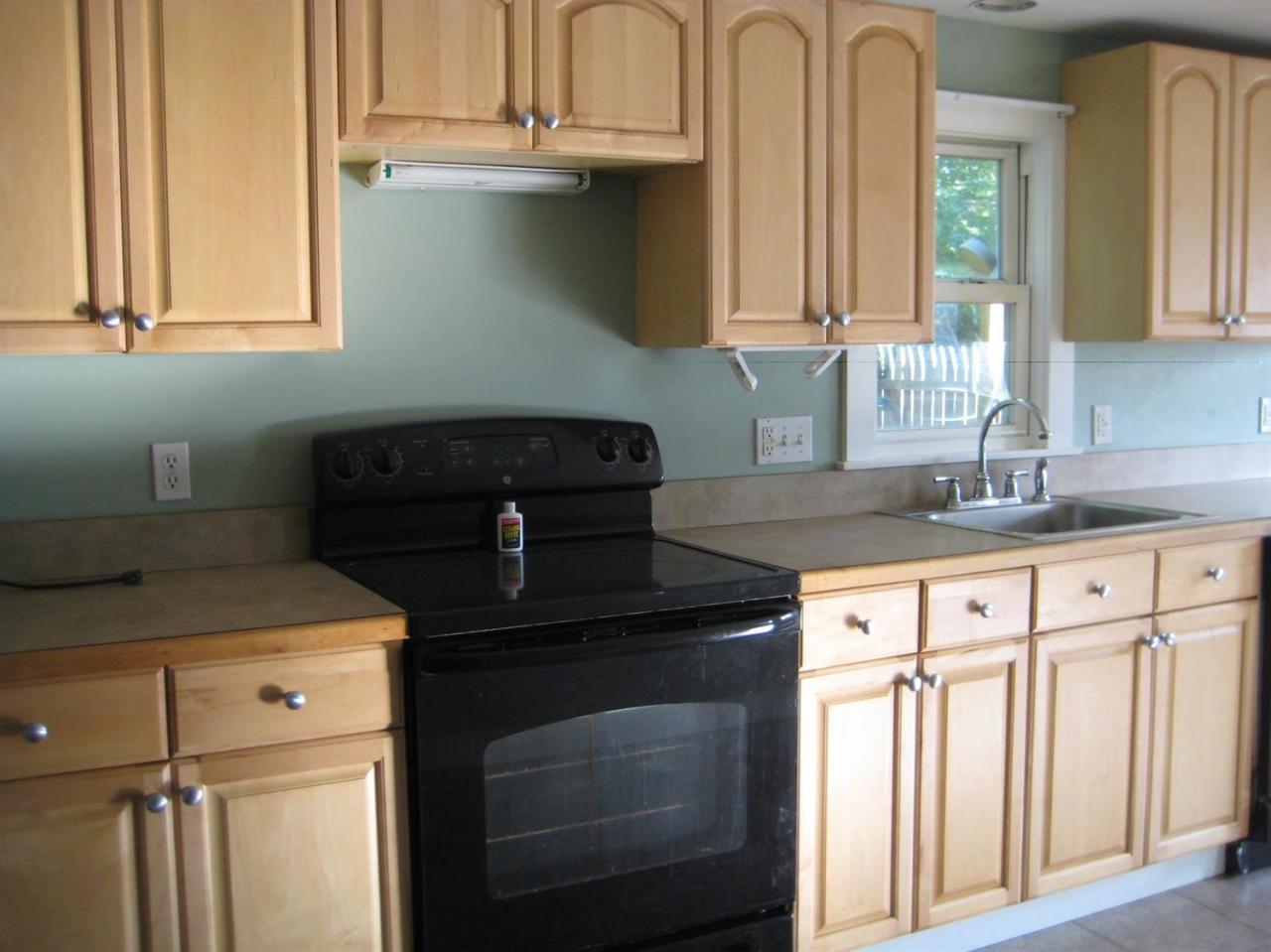 30 Fisher Road Hyannis, MA 02601 - Photo 4 of 8 a kitchen with granite countertop a sink a stove and cabinets