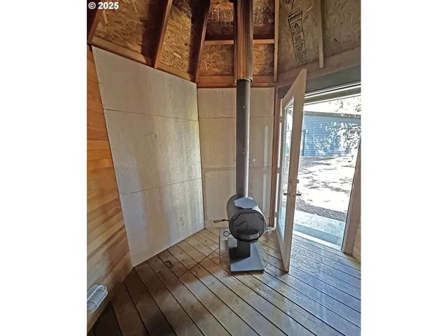 a view of a room with wooden floor and furniture