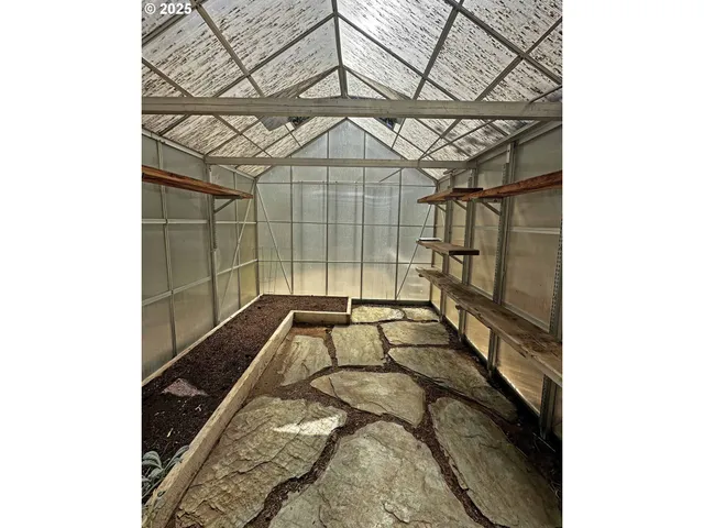 a view of a backyard with a bed and the ceiling fan