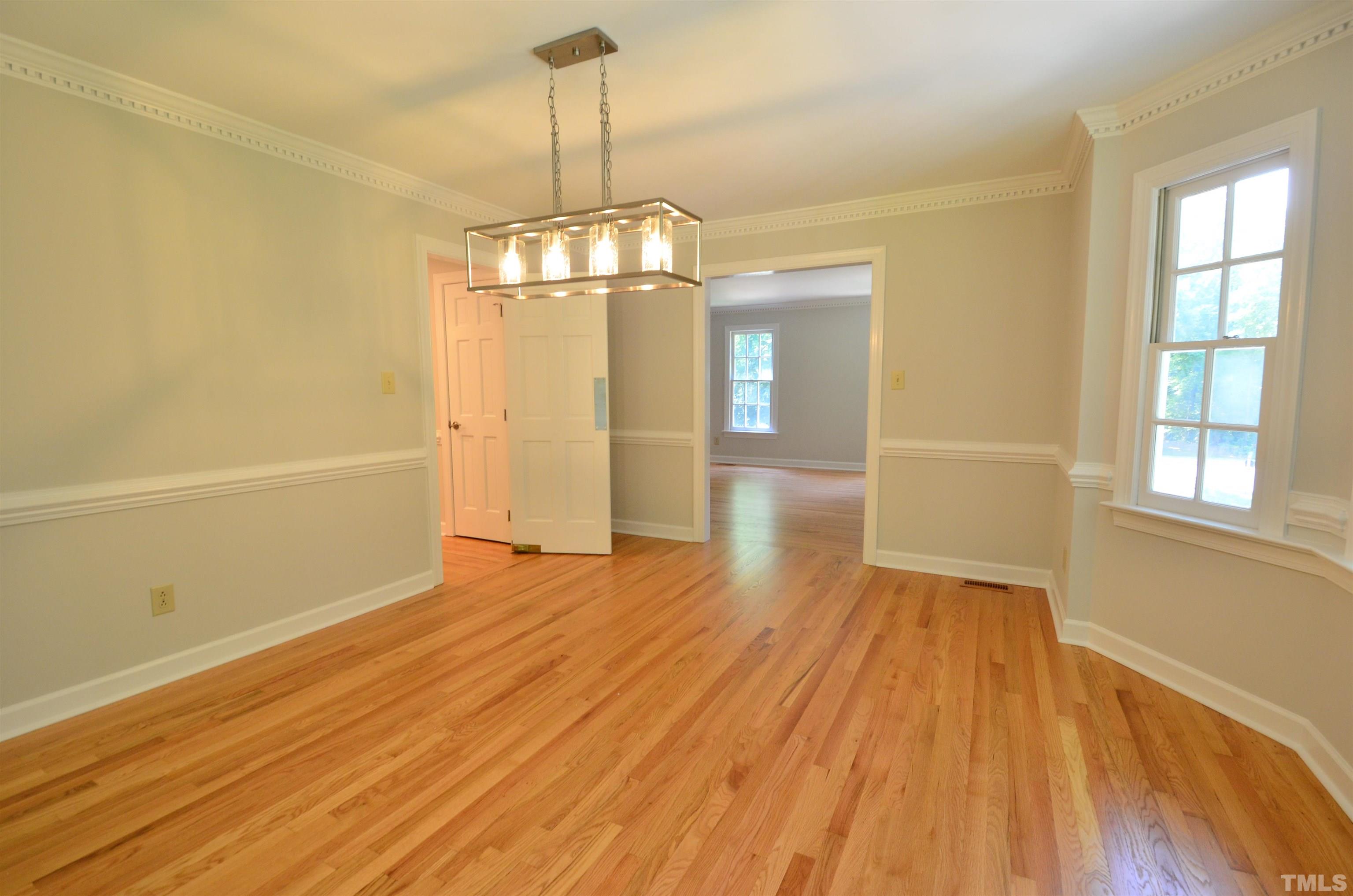 224 Jansmith Lane Raleigh, NC 27615 - Photo 11 of 27 a view of empty room with wooden floor and windows