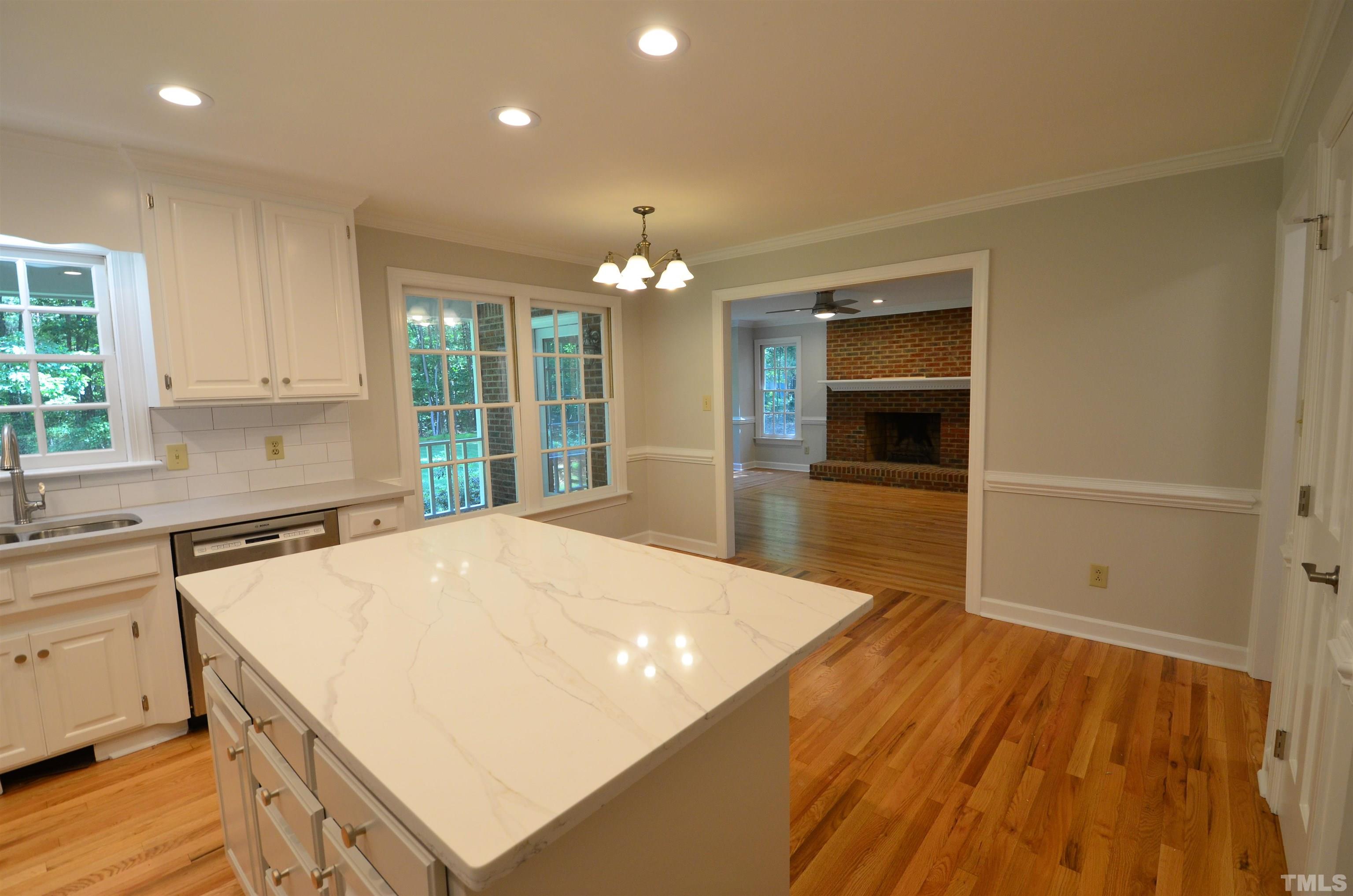 224 Jansmith Lane Raleigh, NC 27615 - Photo 13 of 27 a open kitchen with a sink and dishwasher with white cabinets