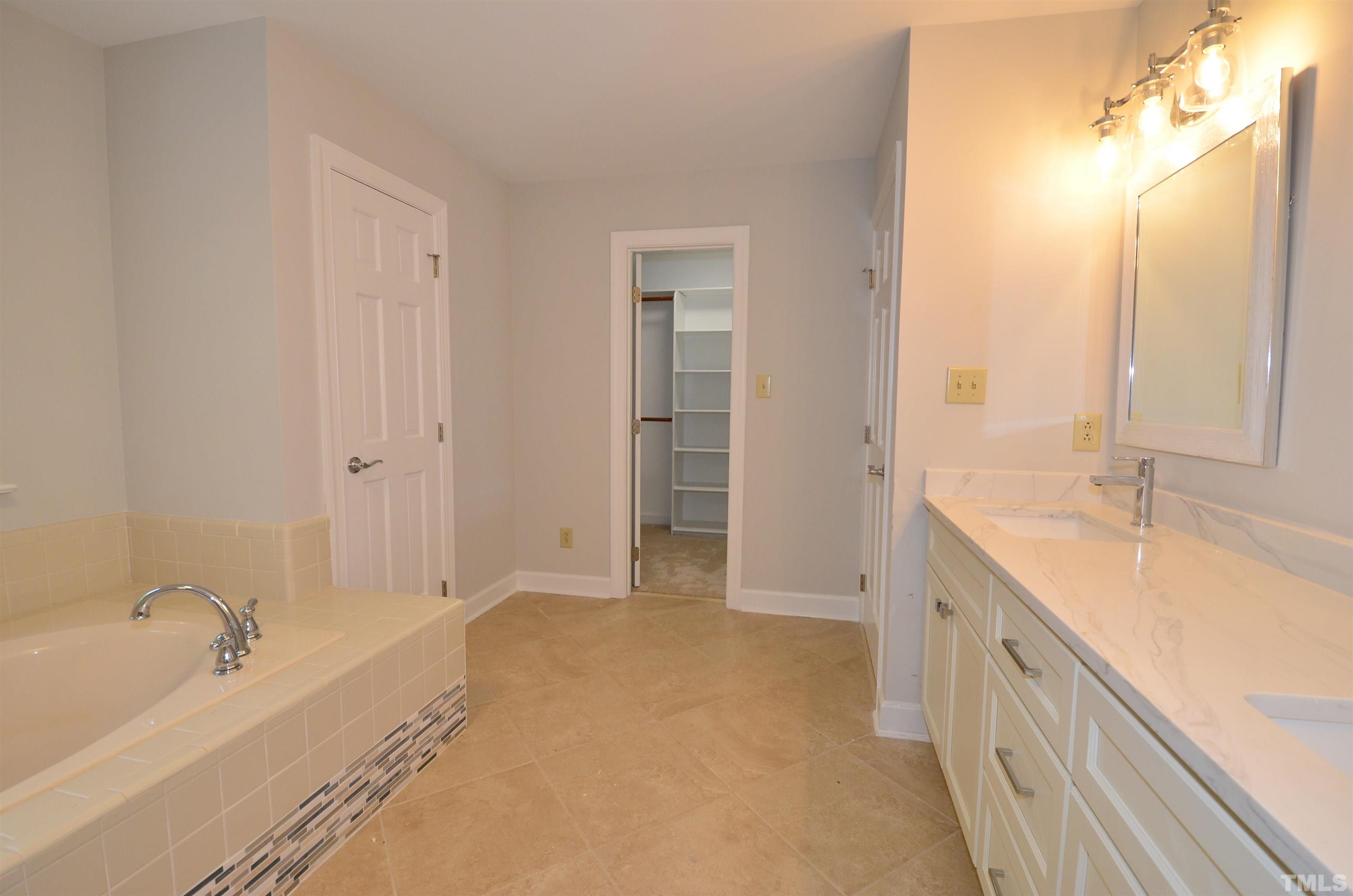 224 Jansmith Lane Raleigh, NC 27615 - Photo 19 of 27 a spacious bathroom with a tub sink and mirror