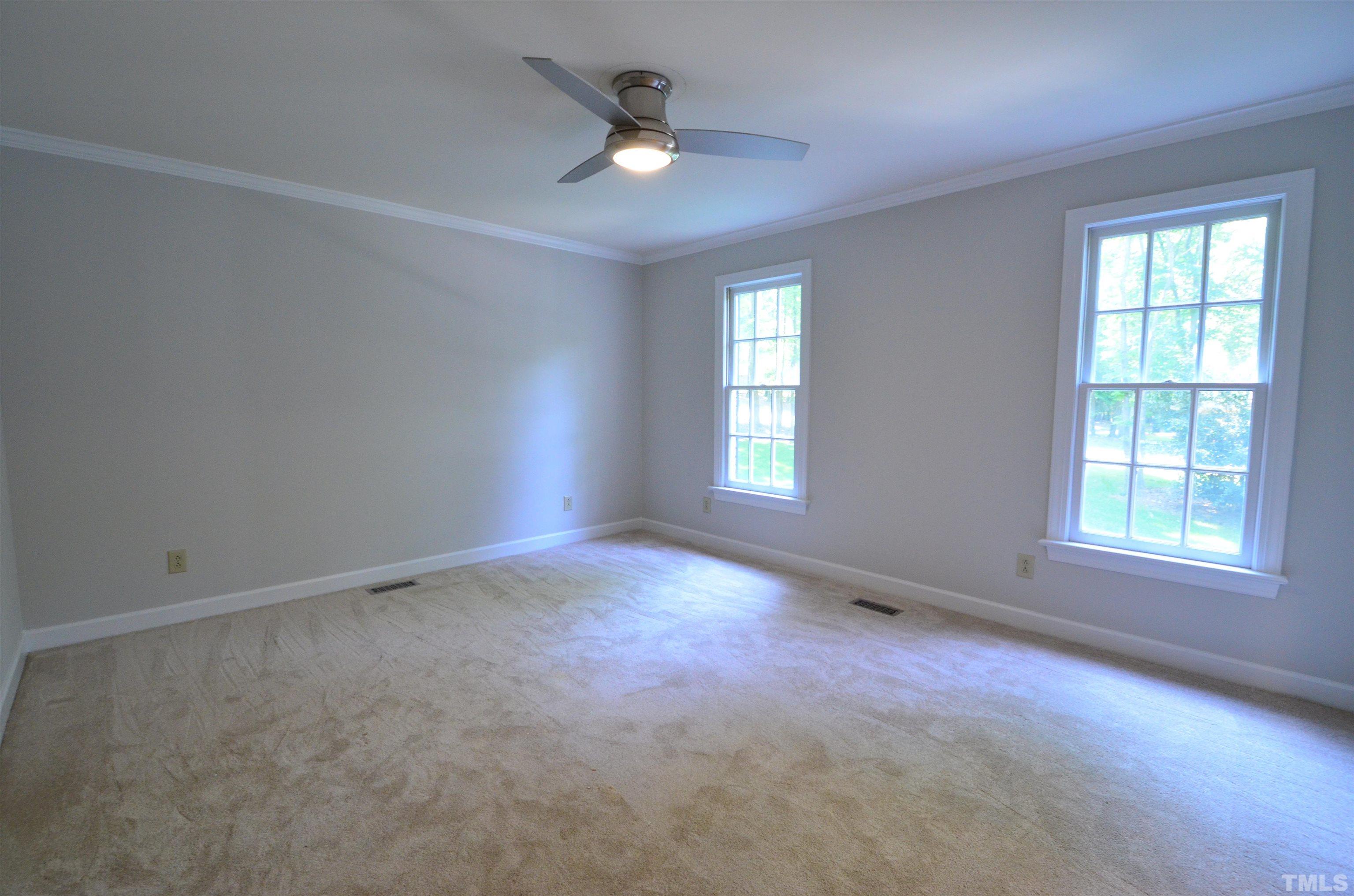 224 Jansmith Lane Raleigh, NC 27615 - Photo 7 of 27 an empty room with windows and ceiling fan