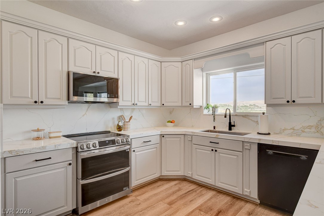 4362 Thistle Street Logandale, NV 89021 - Photo 19 of 99 Culinary aspirations come alive in this well-appointed kitchen, featuring new cabinetry and light-toned countertops.