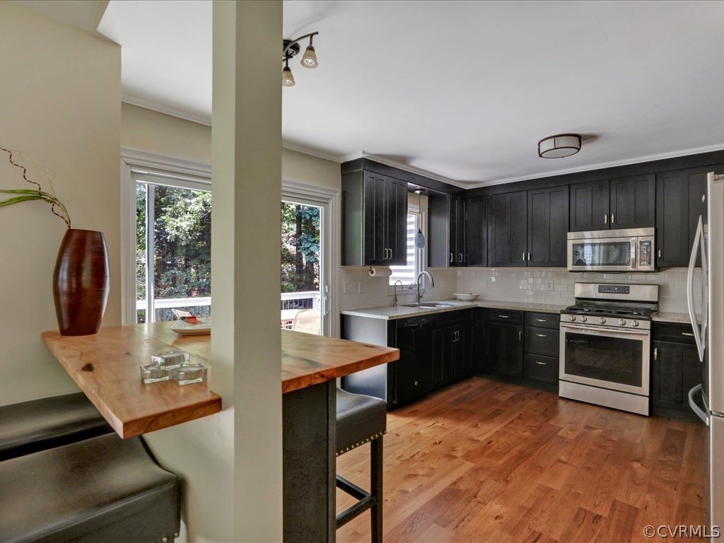 13804 Sandy Oak Road Chester, VA 23831 - Photo 11 of 31 a kitchen with stainless steel appliances granite countertop a stove refrigerator and sink