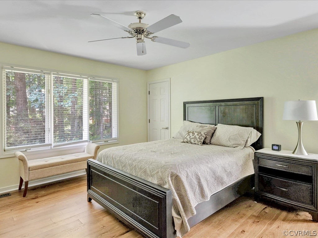 13804 Sandy Oak Road Chester, VA 23831 - Photo 17 of 31 a bedroom with a bed and a chandelier