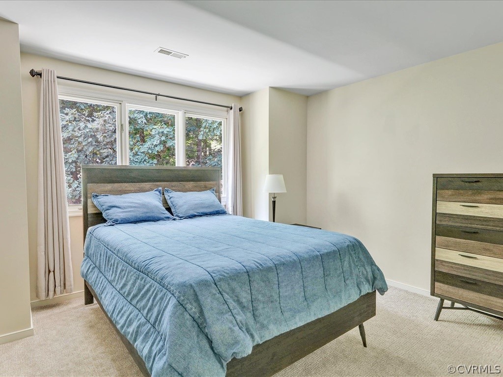 13804 Sandy Oak Road Chester, VA 23831 - Photo 20 of 31 a bedroom with a bed and large window