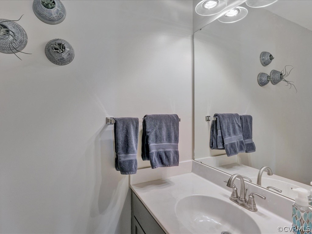 13804 Sandy Oak Road Chester, VA 23831 - Photo 27 of 31 a bathroom with a sink and a mirror