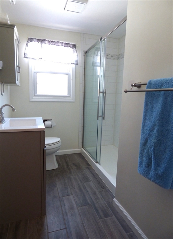 259 Prospect Street Ludlow, MA 01056 - Photo 13 of 30 a bathroom with a sink a toilet a mirror and shower